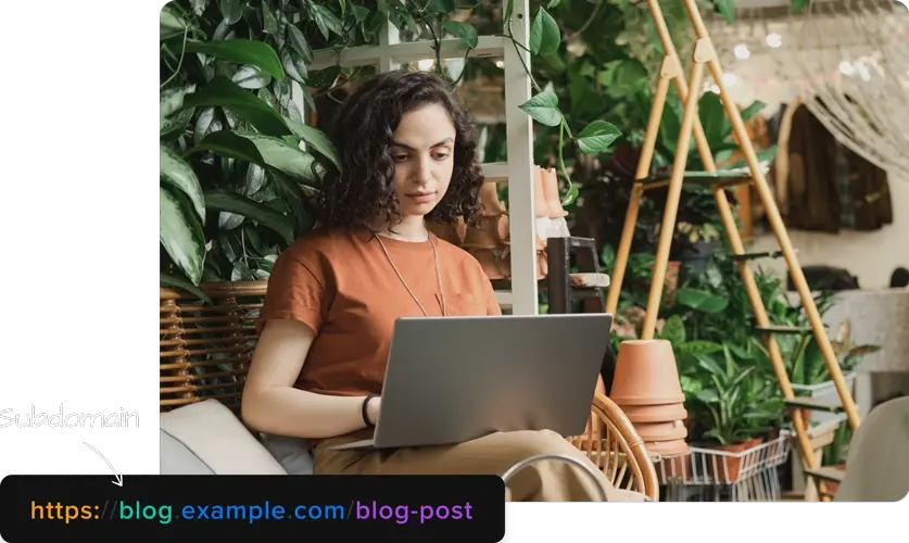 Woman working on laptop and subdomain example