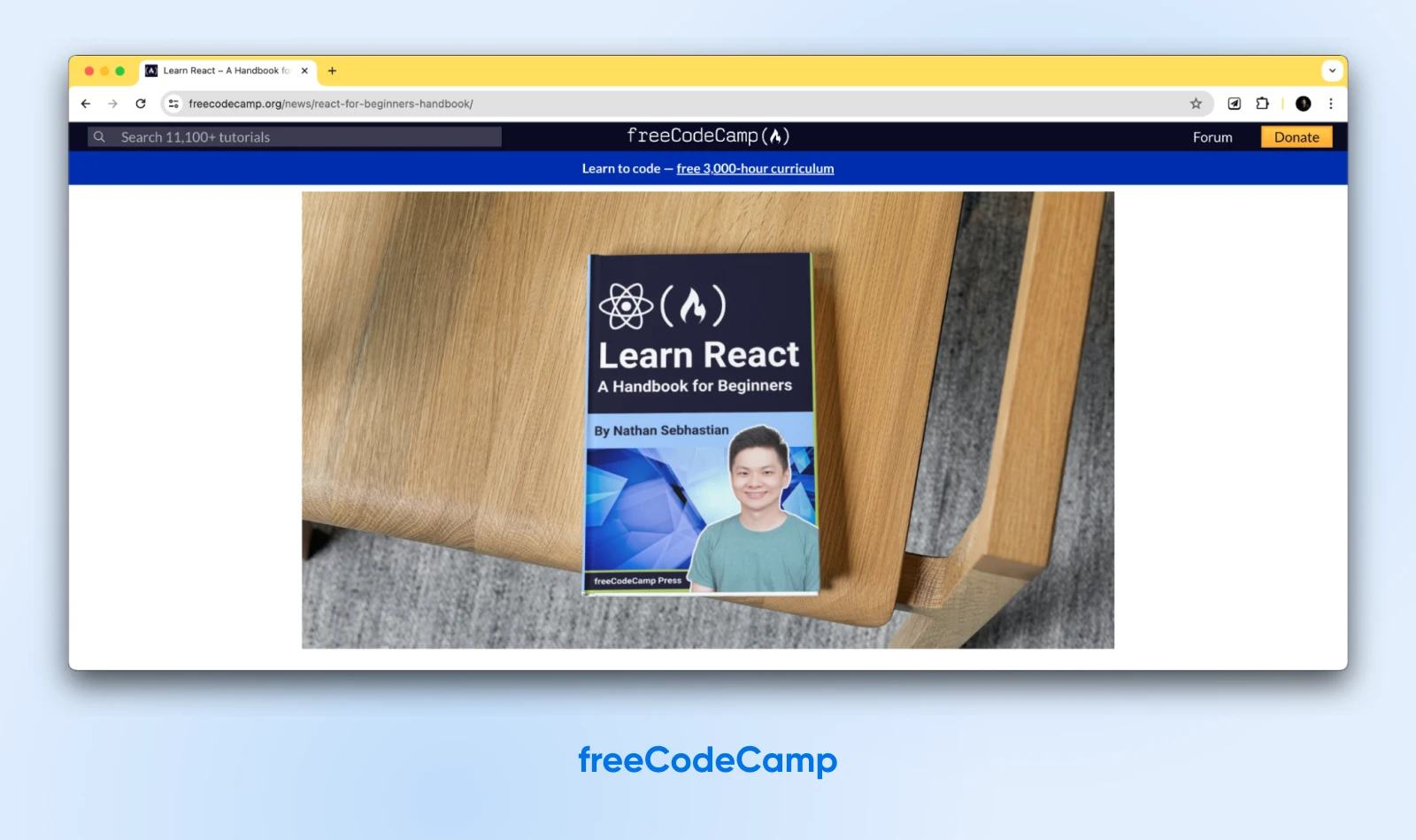 The cover image of freeCodeCamp's "Learn React: A Handbook for Beginners" shows a smiling young man