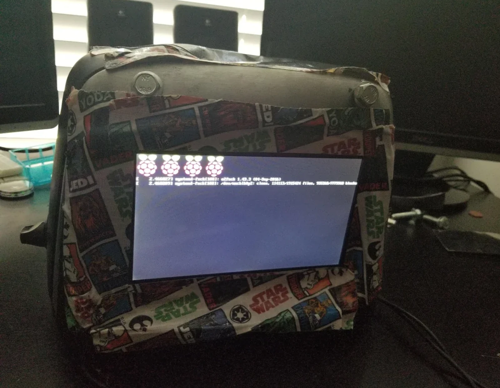 Star Wars themed toaster with stickers and fabric, running Linux as shown by command prompt on small attached screen.